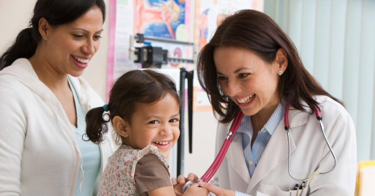 A little girl at the pediatrician with her mother.